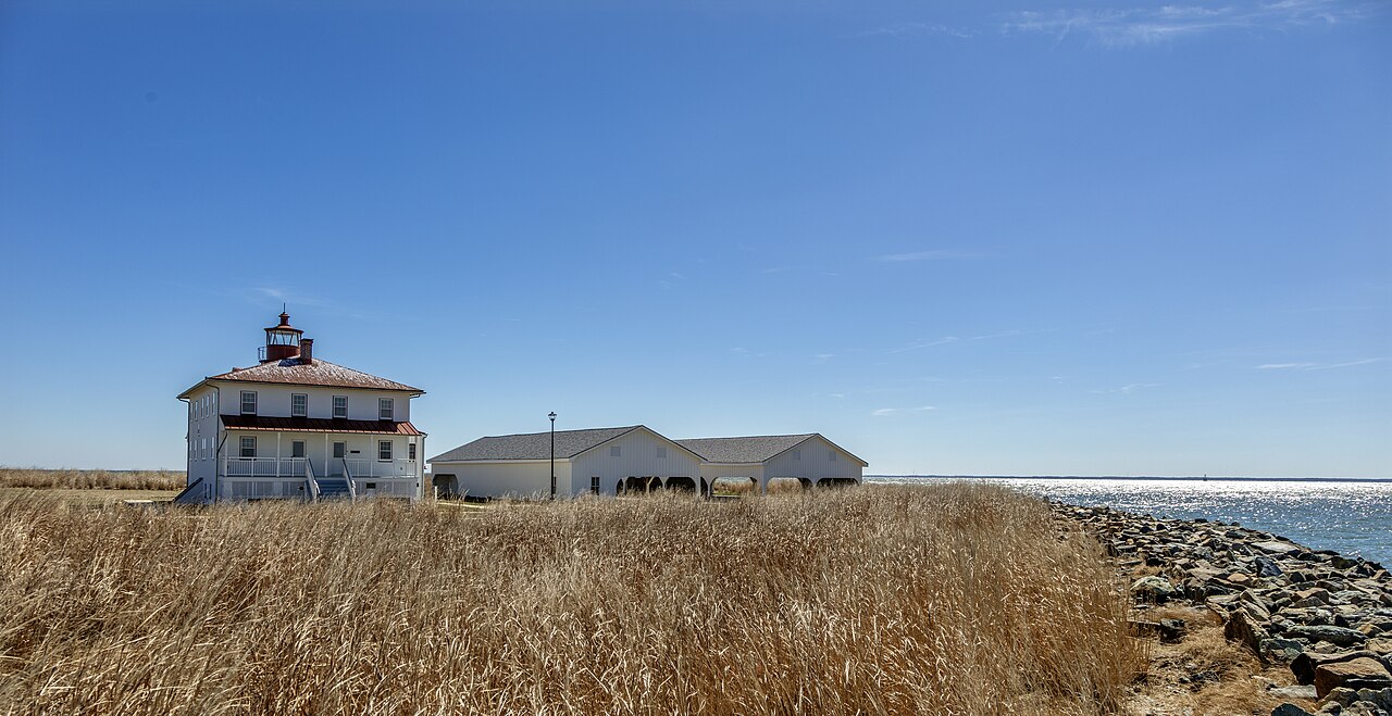 Point Lookout Lighthouse beside golden marsh grass and the Chesapeake Bay in St. Mary's County, Maryland.