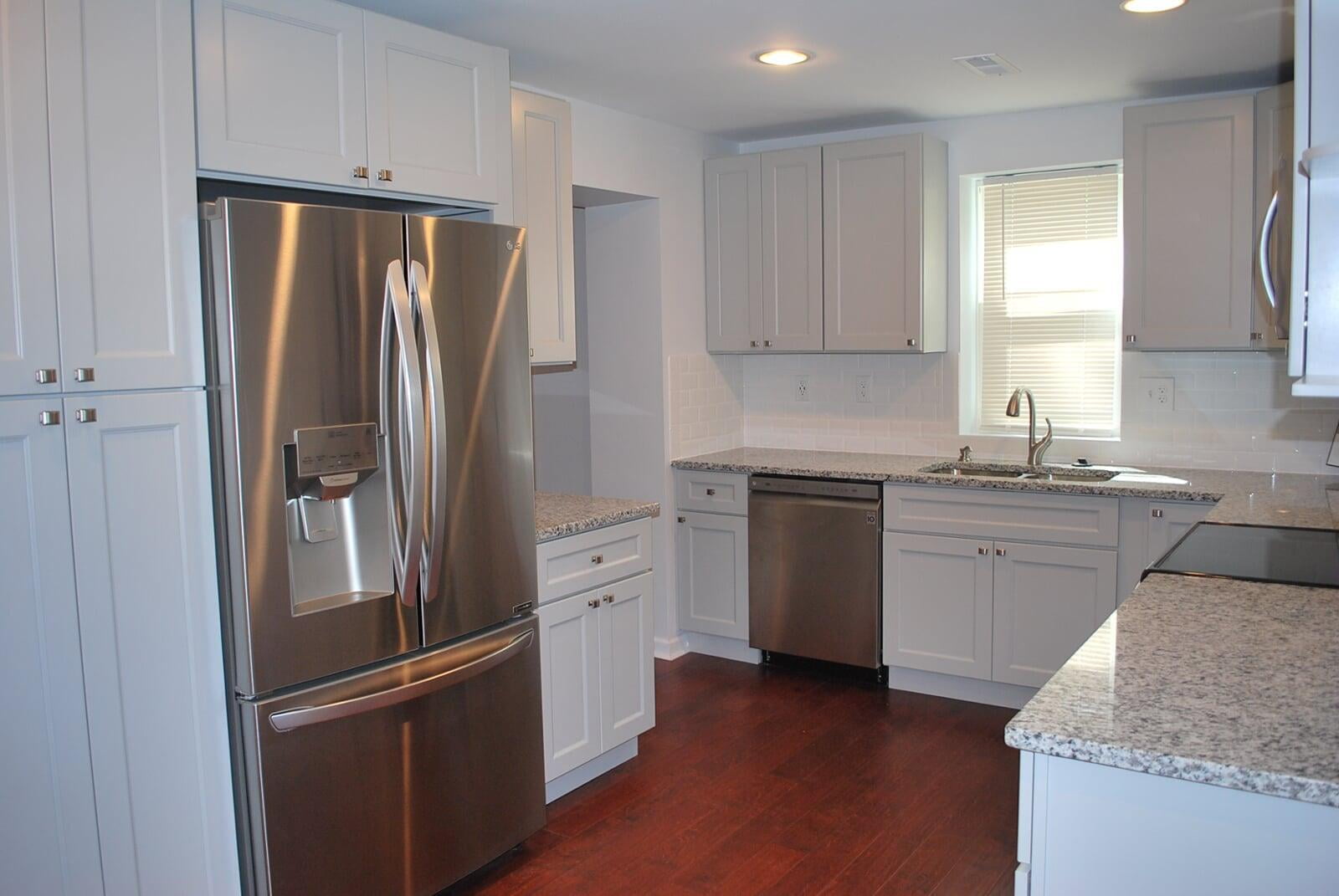 Mechanicsville kitchen with light cabinetry, granite counters, and wood flooring