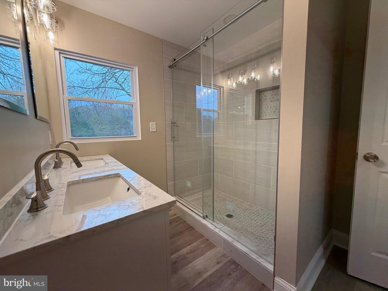 Mechanicsville renovation: bathroom with a light vanity and tiled glass shower